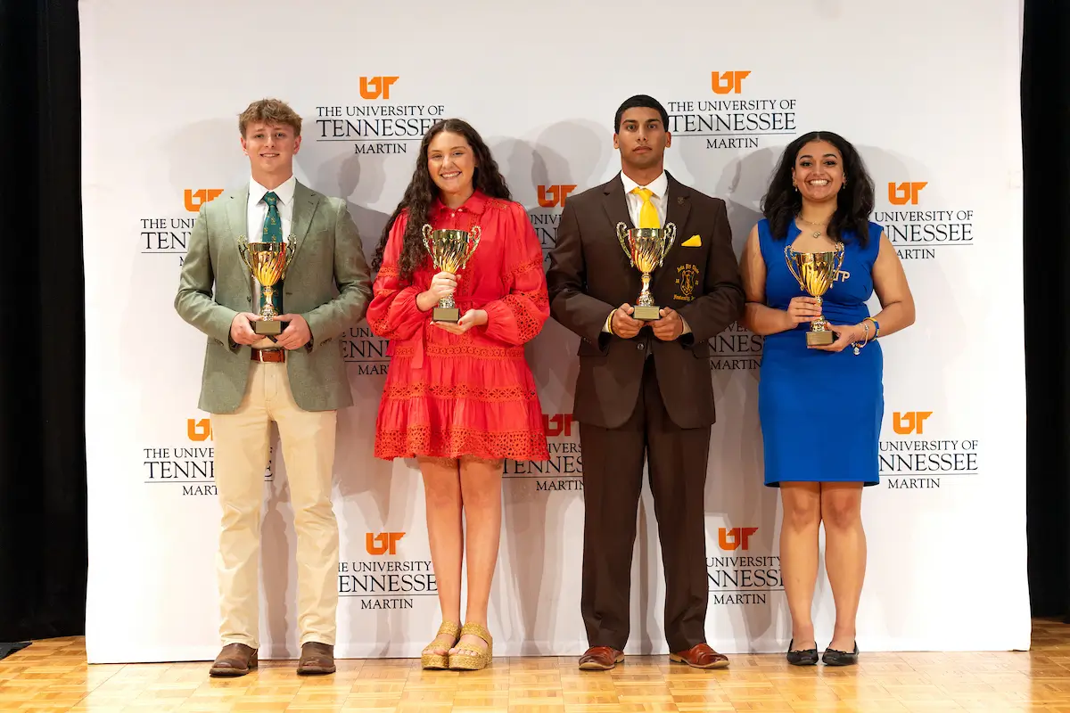 students in a line holding awards during the greek awards ceremony