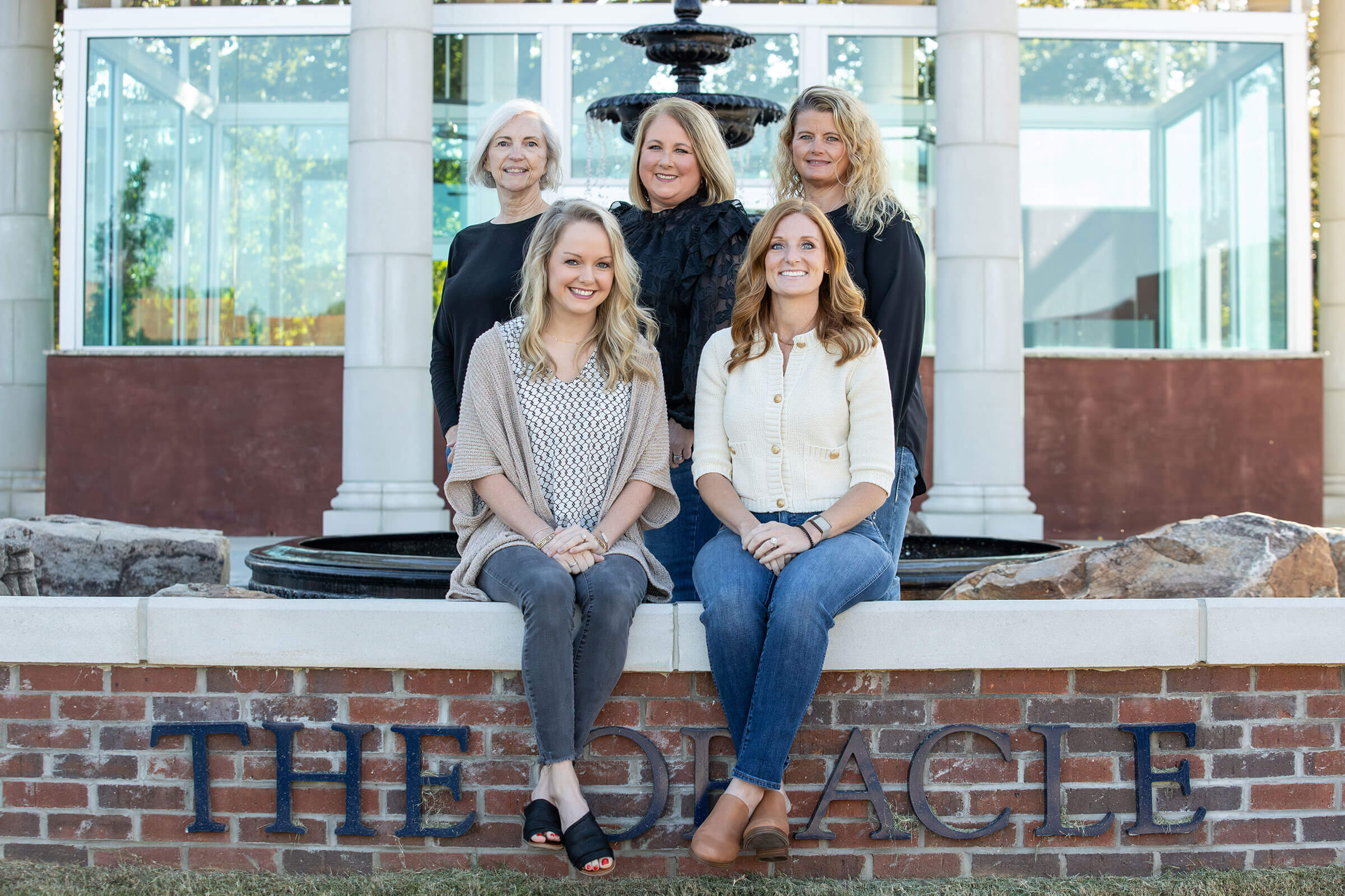 Student Health Staff members sitting in front of the Oracle Fountain